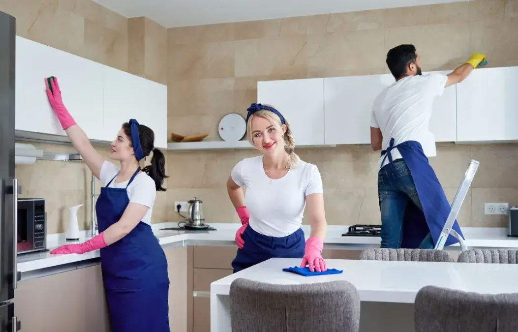 Professional cleaning team tidying up a modern kitchen.