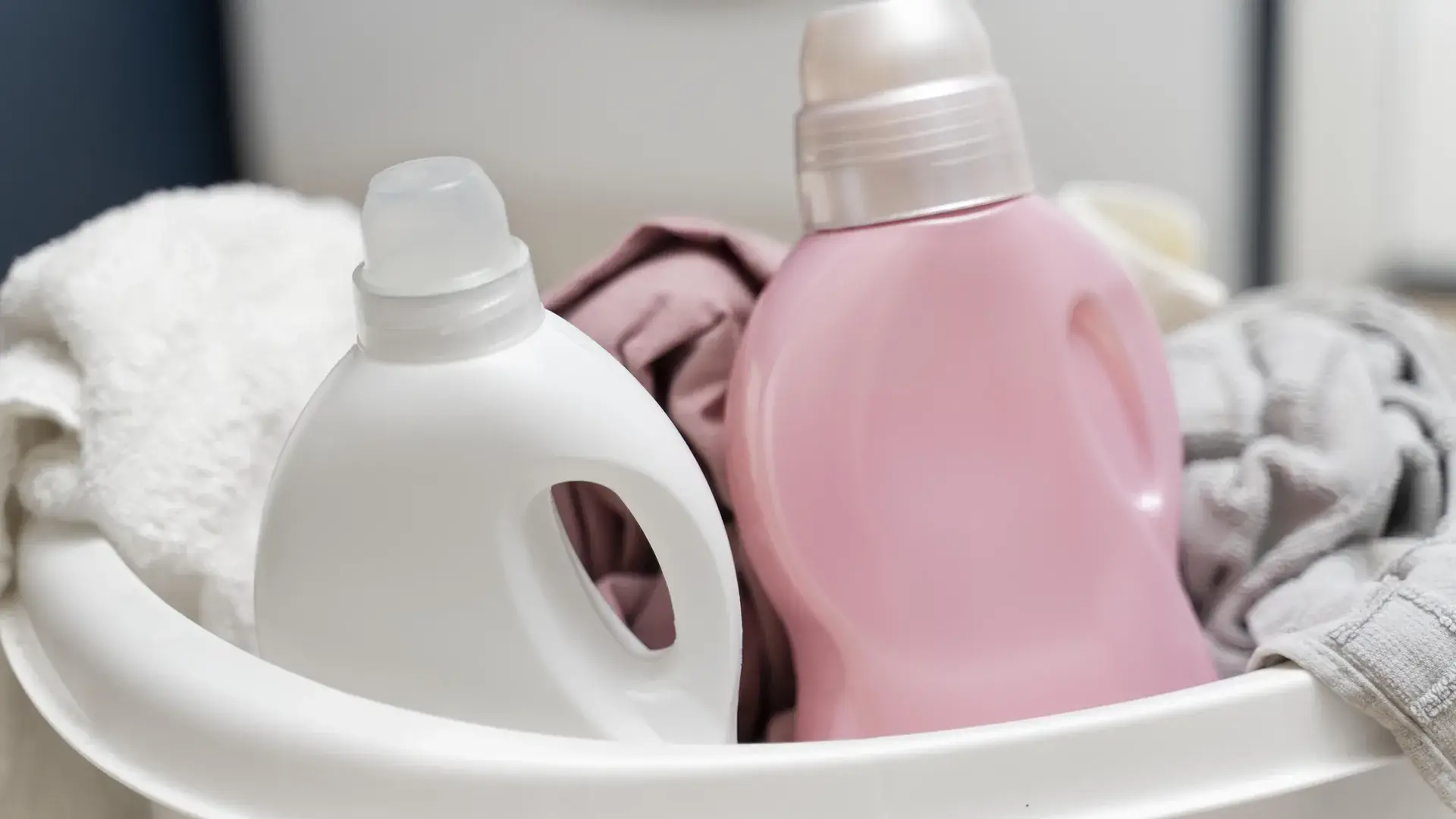 Laundry detergent bottles in a clothes basket