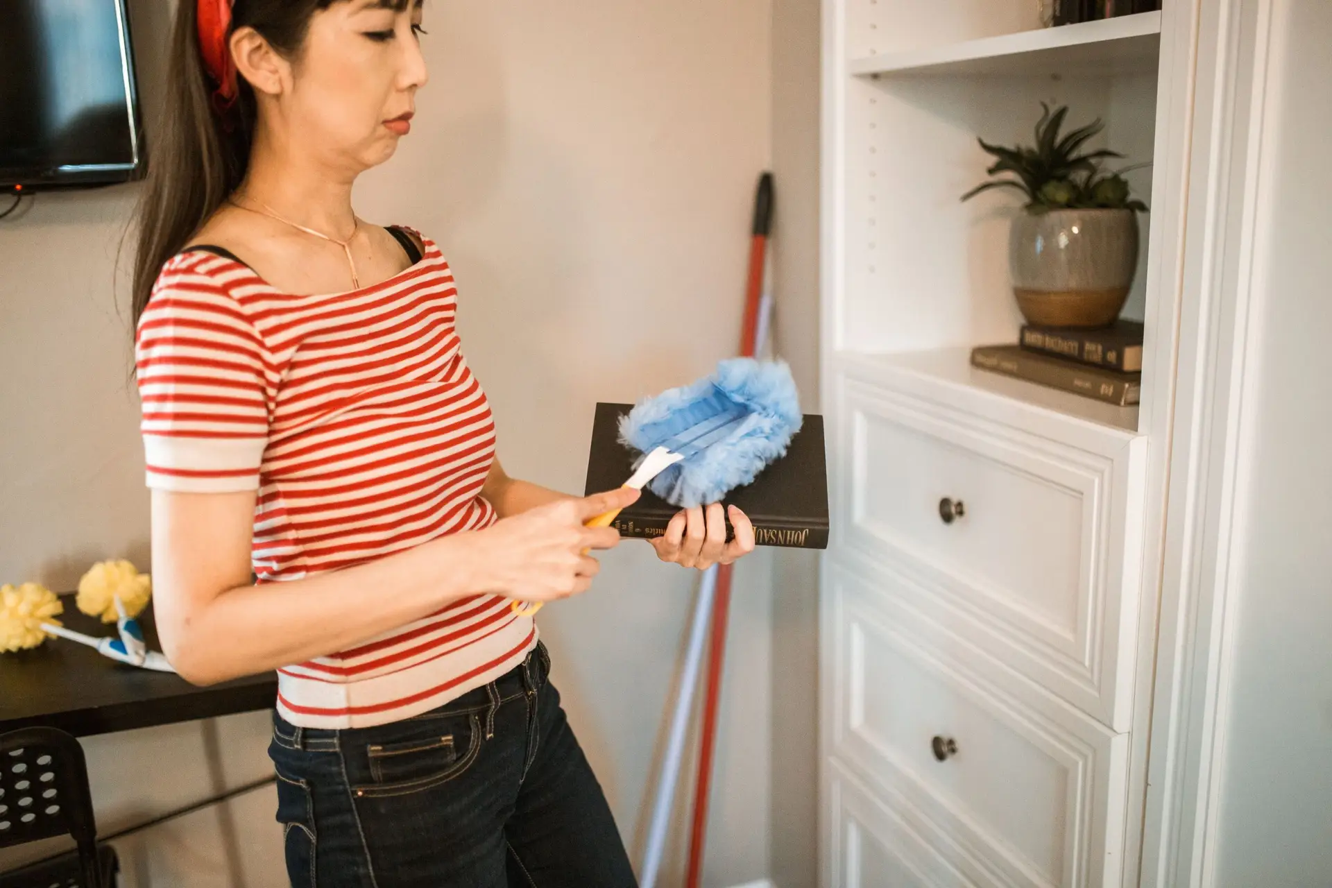 Cleaning professional dusting cabinets to reduce fall allergens in an Argyle Texas home
