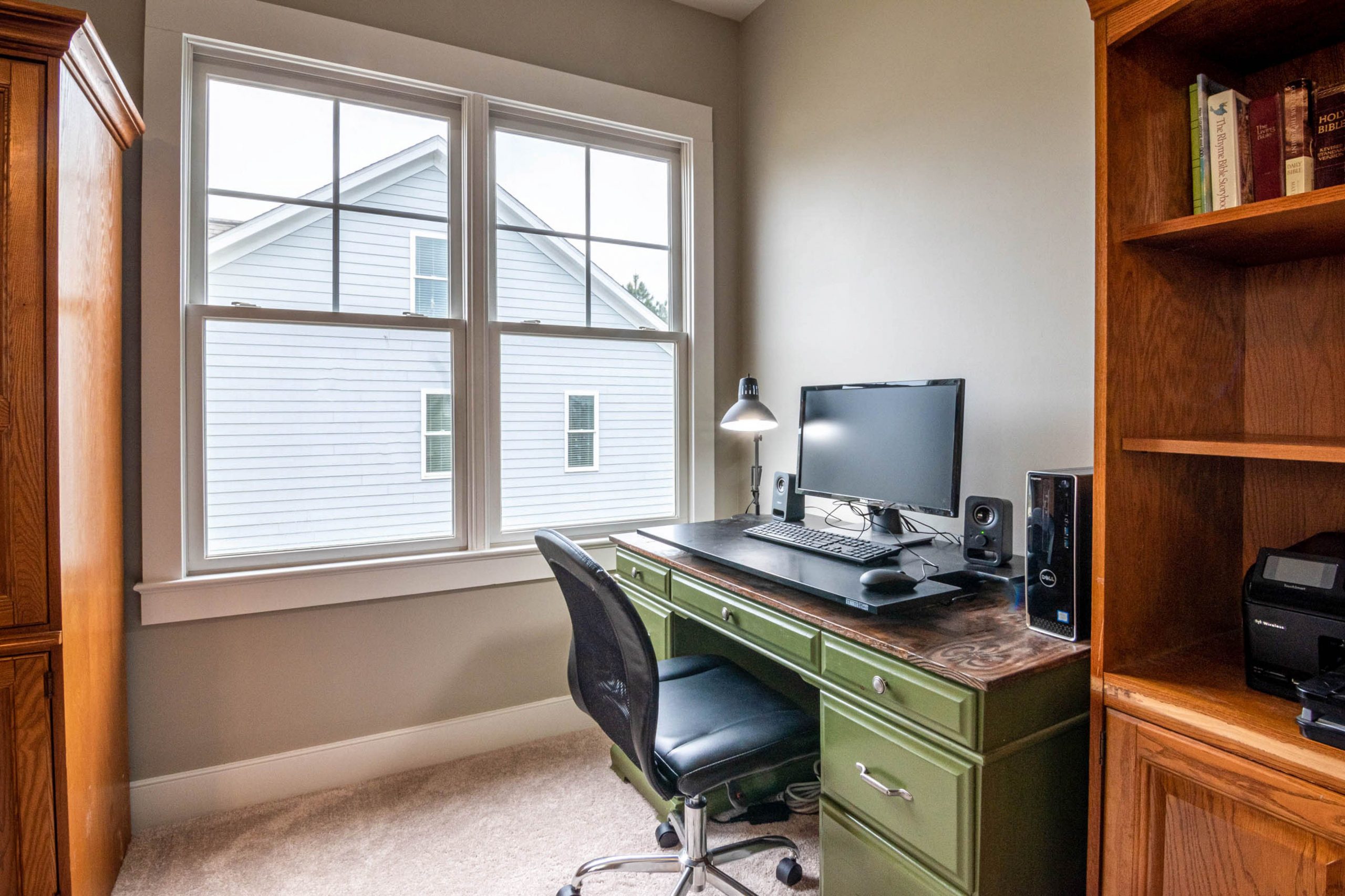 A calm, well organized home office desk near a window, reset and ready for a new work routine