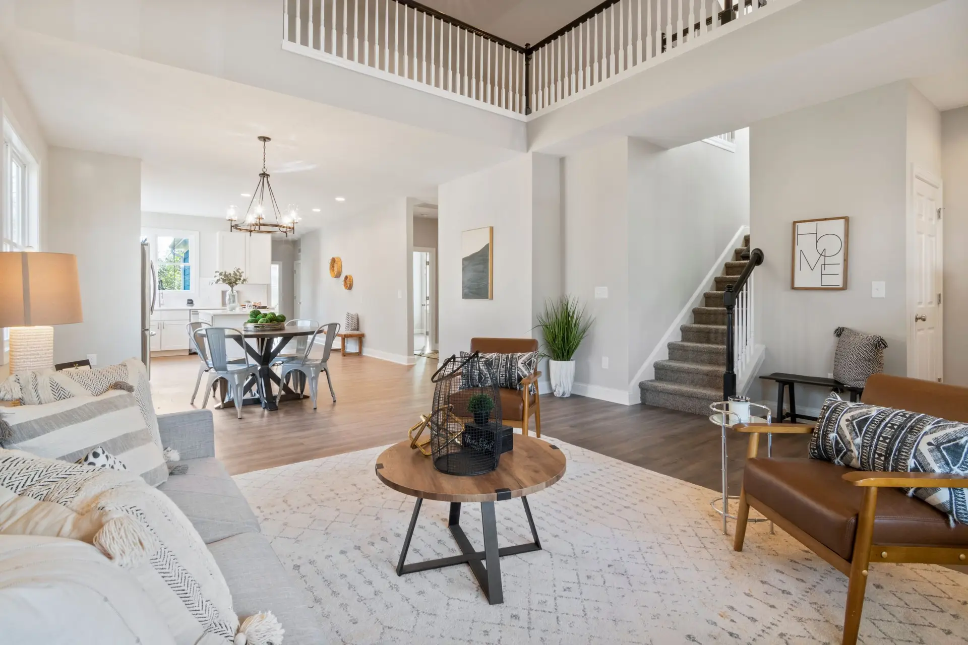 Bright open concept living room with staircase in a large Lucas TX home