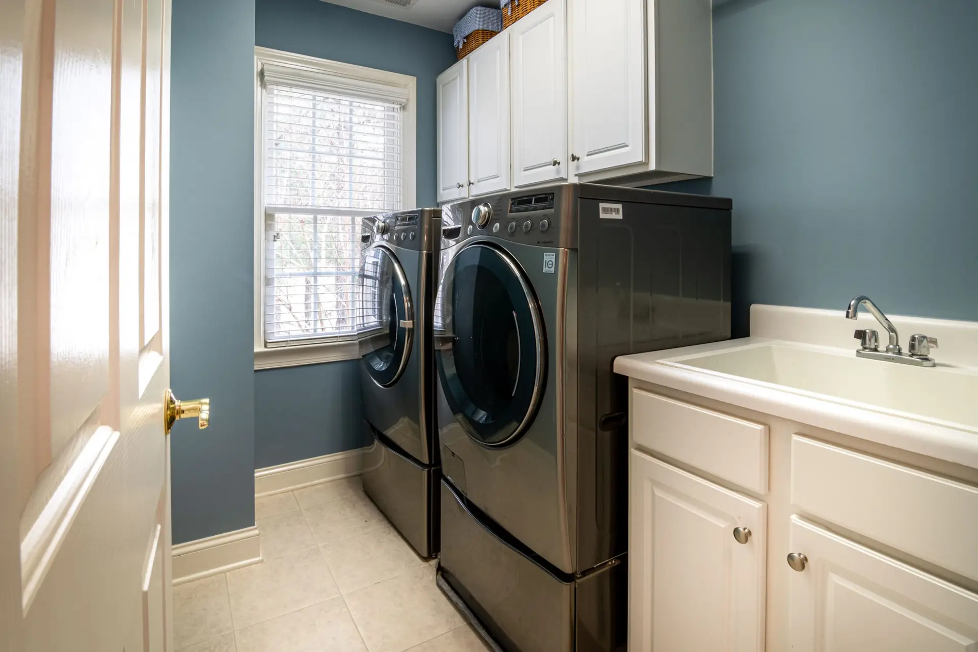 Clean modern laundry room with washer and dryer and natural light
