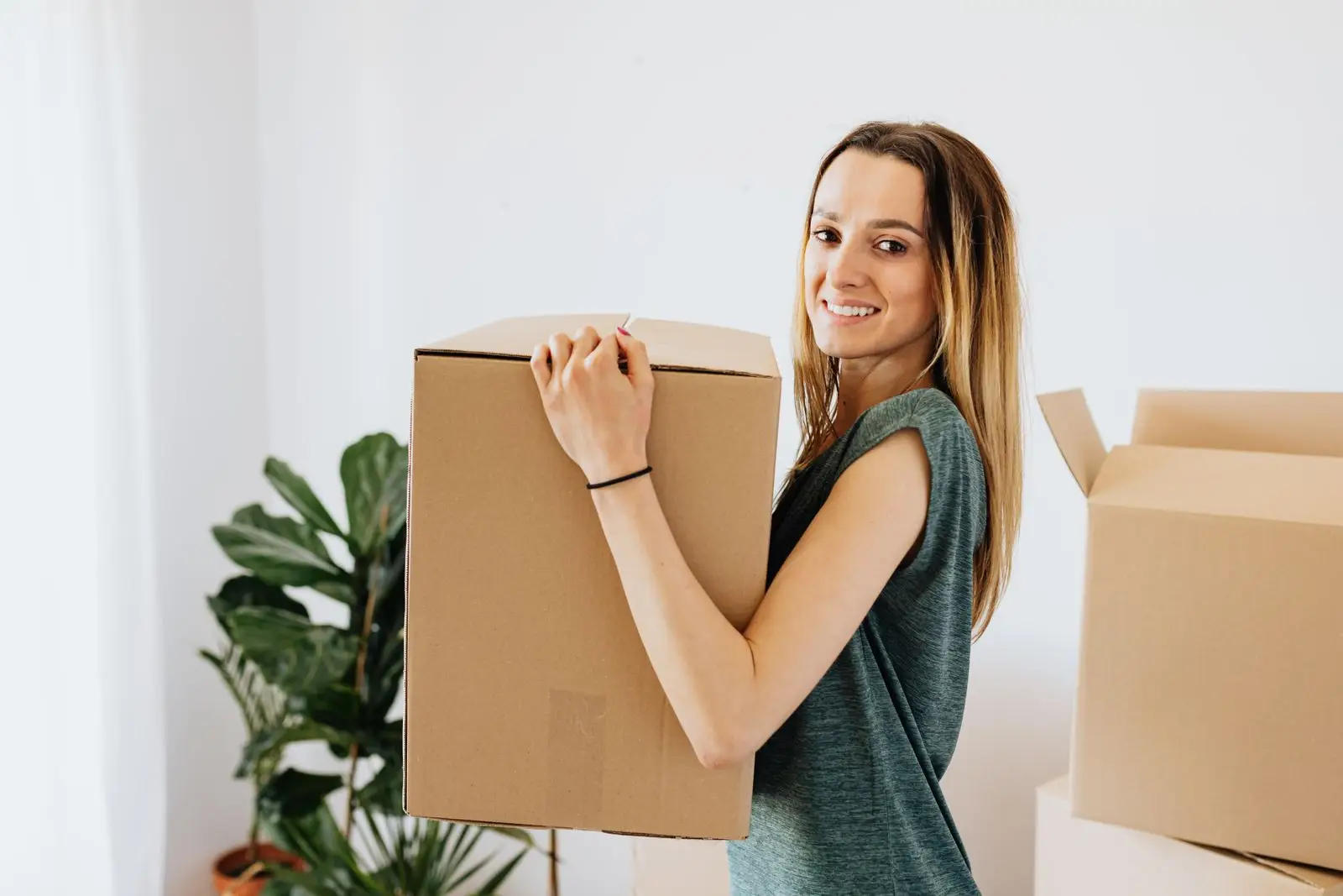 Young renter carrying a moving box on lease turnover day in Denton Texas