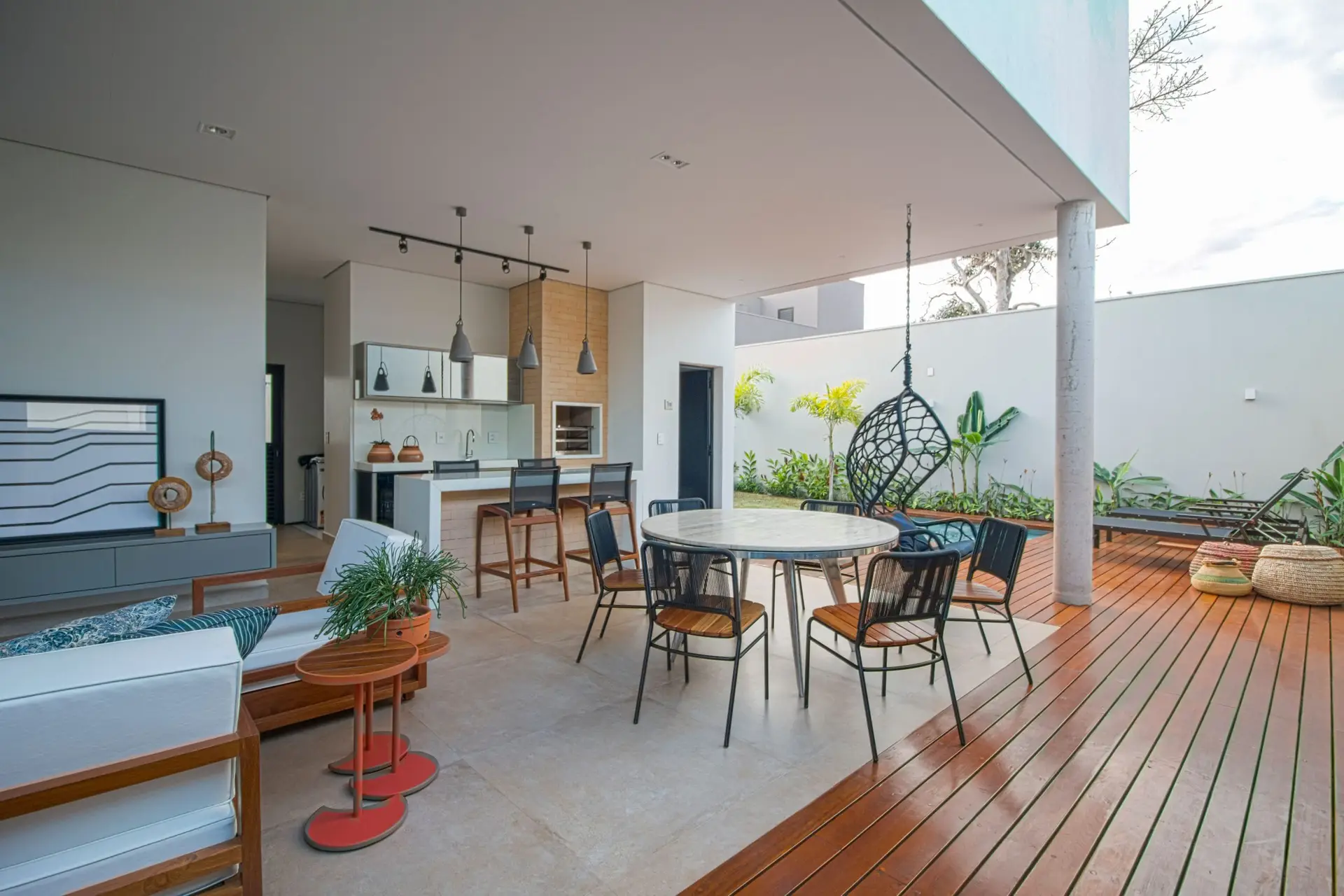 Bright modern covered patio with dining table and outdoor seating