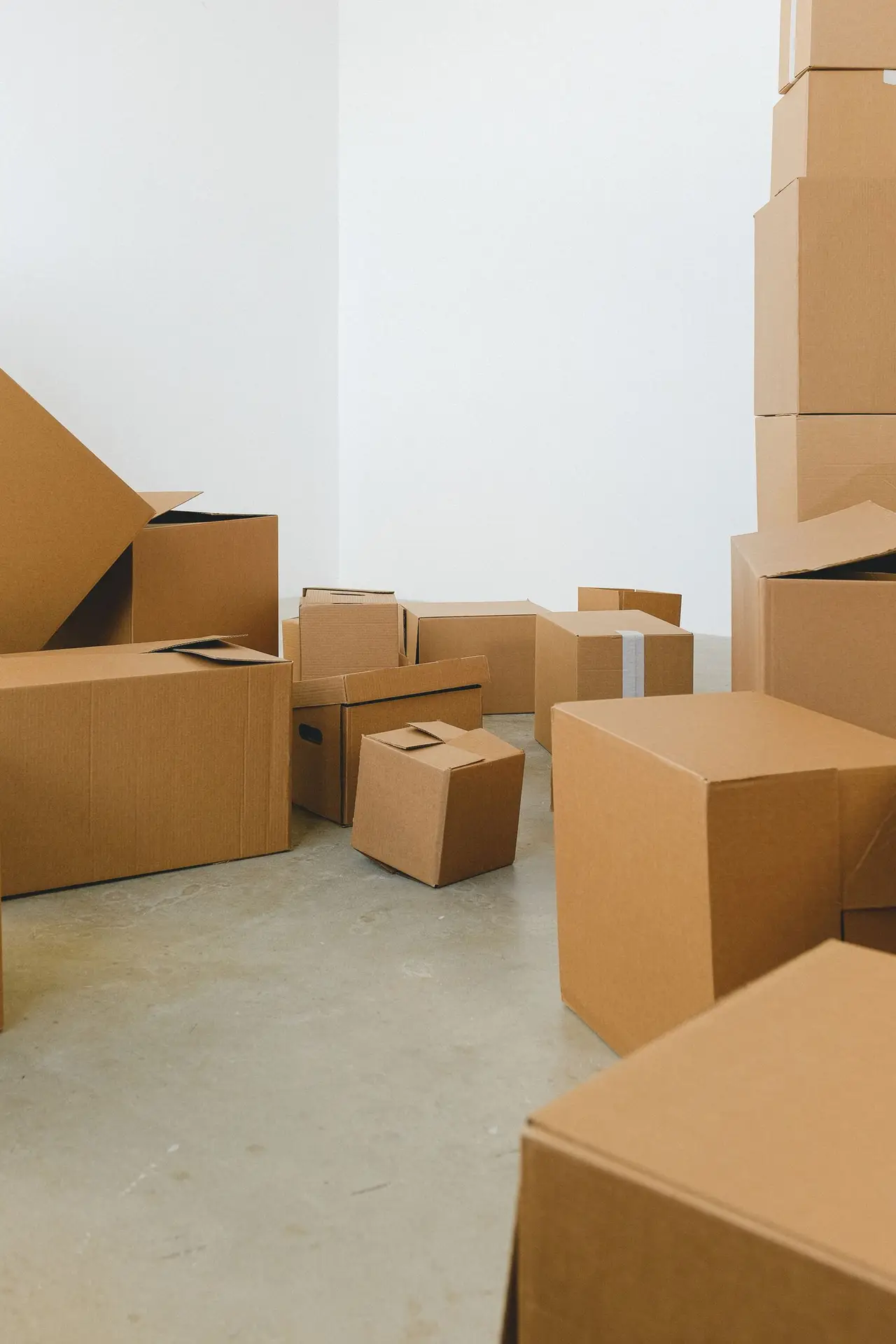 Moving boxes stacked in a bright empty room during a relocation in Allen Texas