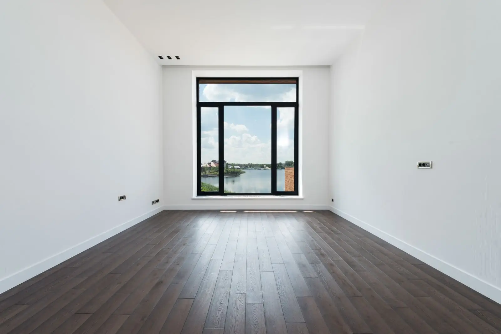 Bright empty bedroom with wood floors in a family home being sold in Fairview TX