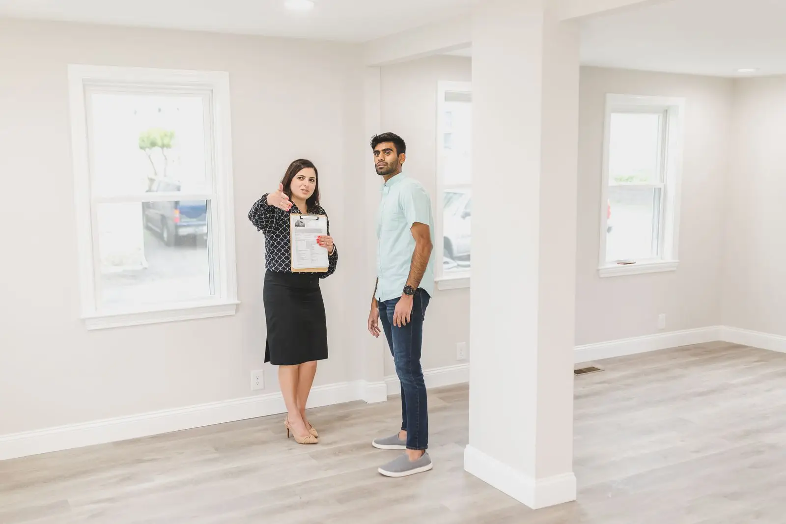 Couple walking through a bright empty home in Anna TX deciding what a move in cleaning can fix