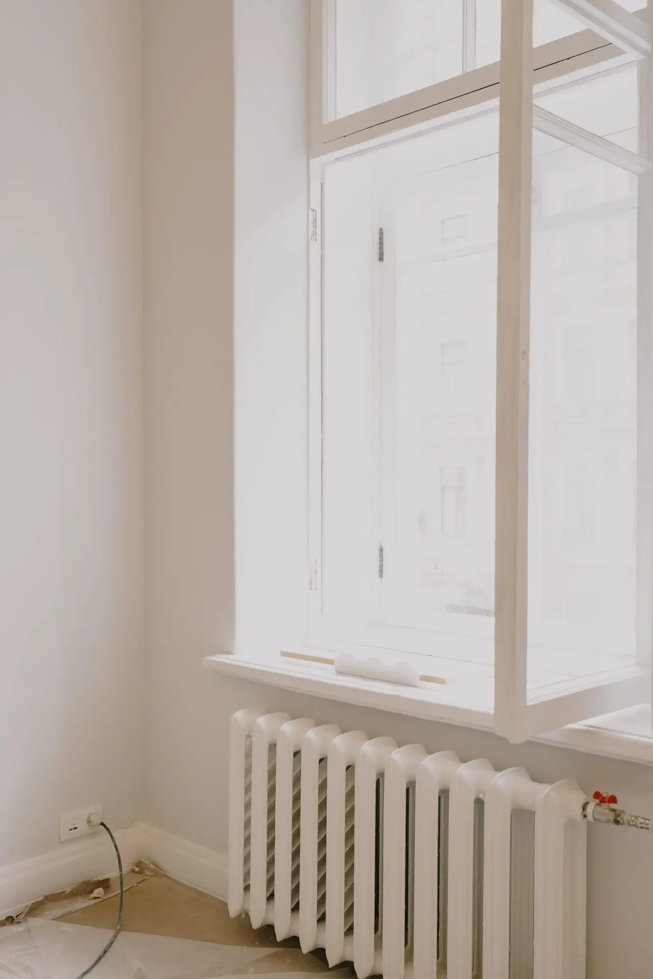 Bright room with a window and heater representing fall heating season in McKinney TX